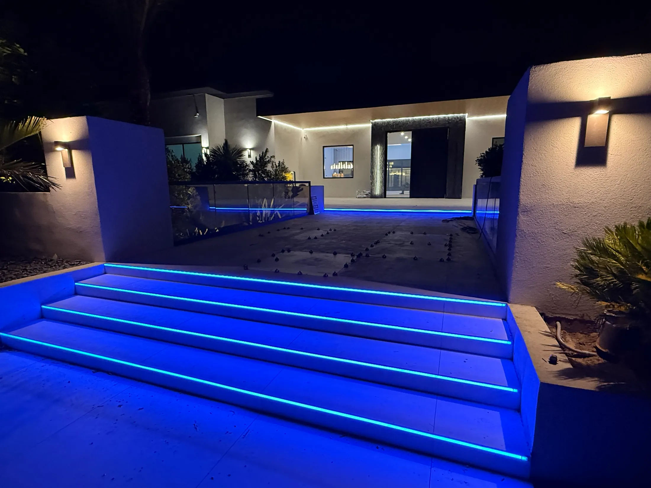 Modern home entrance with custom LED landscape lighting installed by SAR Electric